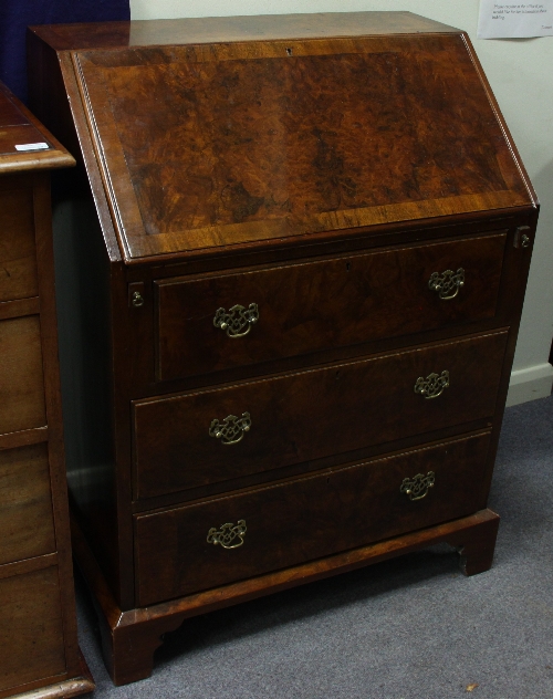 A burr walnut bureau, the fall enclosing a fitted interior above three drawers, on bracket feet,