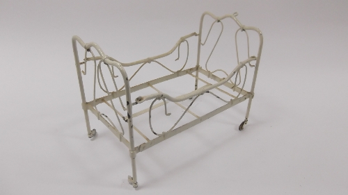A dolls' cream painted bedstead with wire  scrollwork and the base for the same, 19cm (7.5") wide