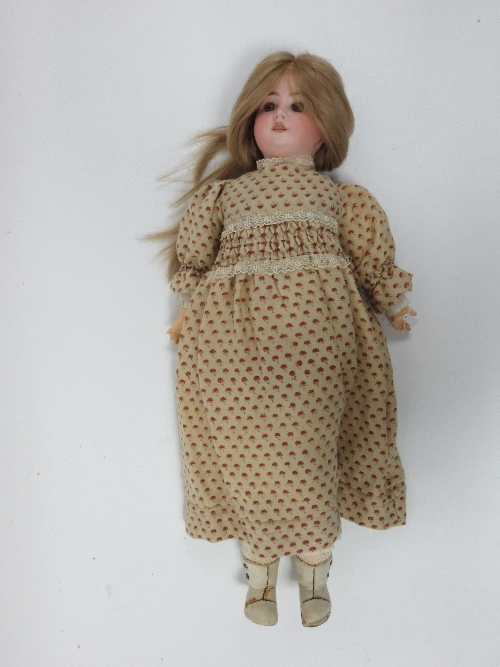 A German bisque head doll, with fixed brown eyes and open mouth, jointed composition body and