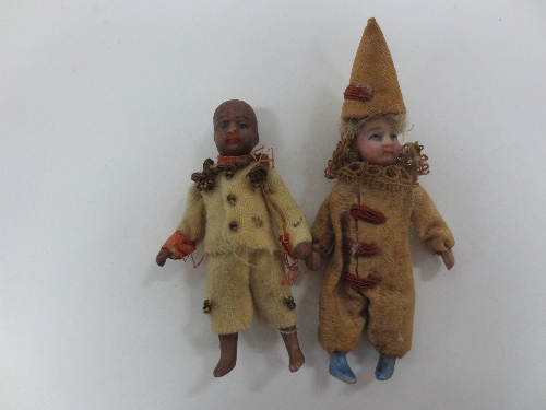 A small jester doll with bisque head, hands and feet, in a contemporary costume, 8cm (3") high and a