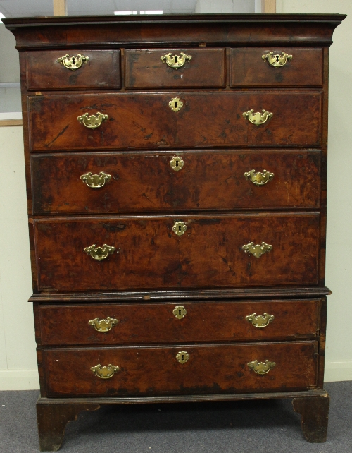 A George II walnut chest of drawers, circa 1740, the upper section fitted three short above three