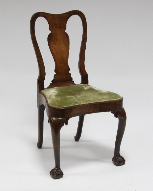 A George I walnut chair with vase shaped splat and drop in seat on cabriole legs with claw and