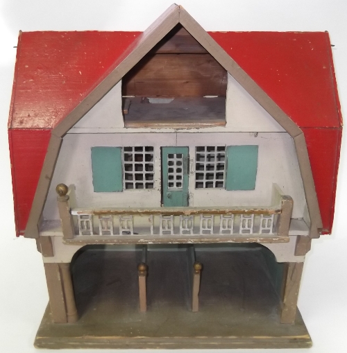 A toy stable and groom's lodging with loose boxes and accommodation above, under a red gabled roof