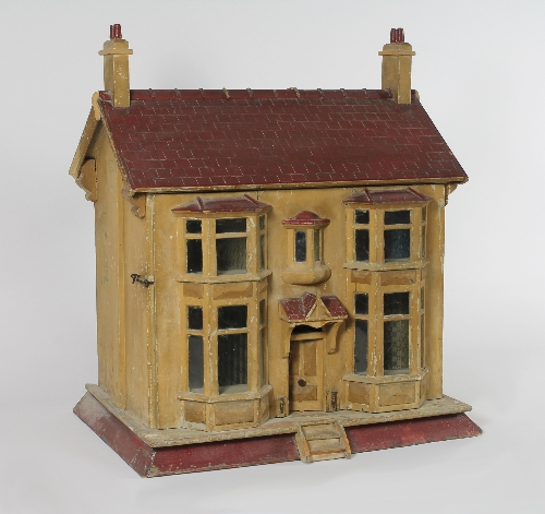 A wooden dolls' house of two storeys, 71cm (28") wide and a selection of dolls' house furniture,