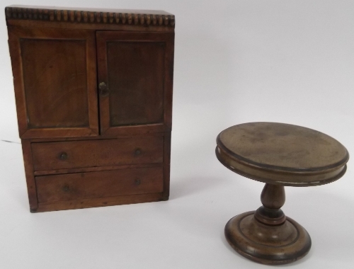 An early Victorian mahogany 'apprentice' wardrobe, 24cm (9.5") high and a circular dining table