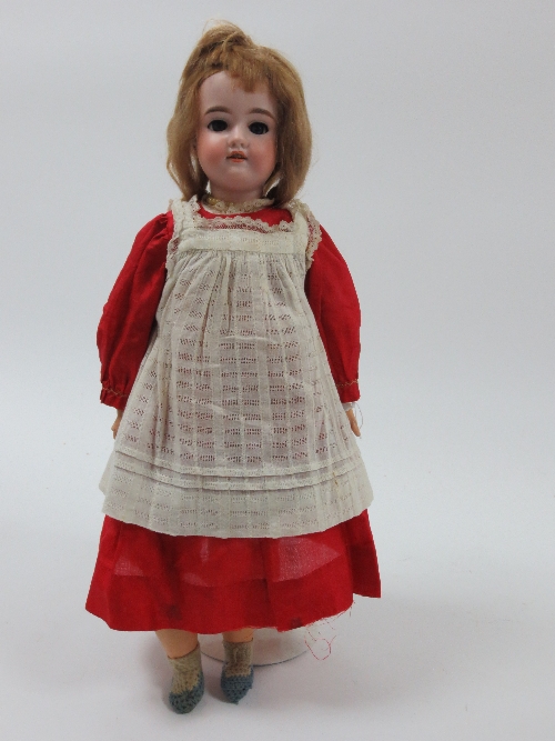 An Armand Marseille bisque head doll, the head impressed CAMA, with weighted eyes, painted