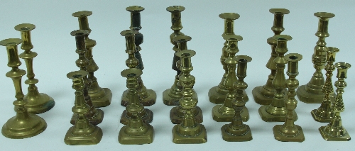 Ten pairs of baluster brass candlesticks, various