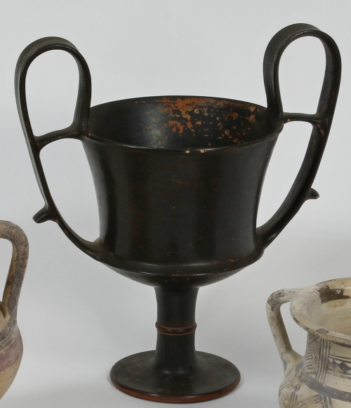 A south Italian black glazed pottery kantharos, 4th Century BC, with loop handles to the flared cup,