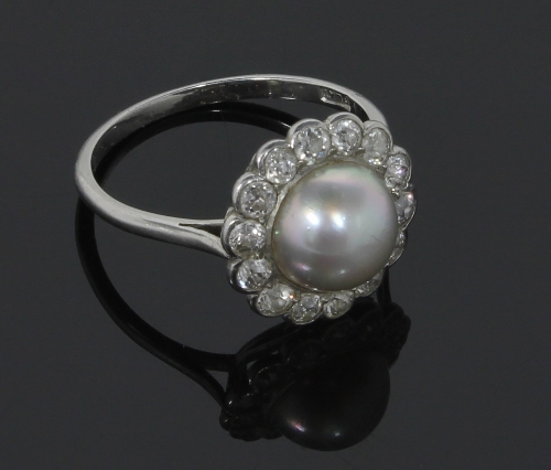 A pearl and diamond cluster ring, the central pearl to a surround of fourteen diamonds on a platinum