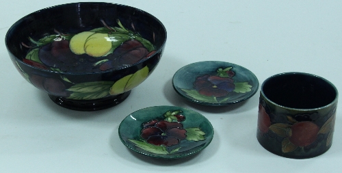 A Moorcroft cylindrical pot 9cm (3.5"), a Moorcroft bowl 21cm (8.25") and two saucers 11.5cm (4.5")
