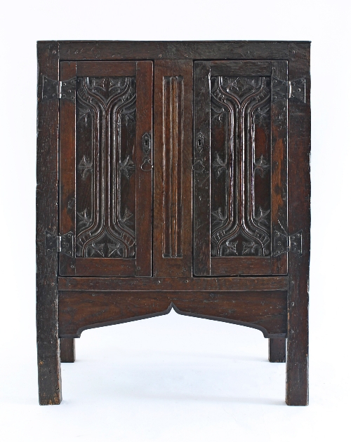 A late 16th Century German oak cupboard with plank top and panelled sides with two parchemin