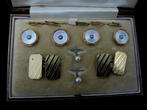 A gentleman's dress set, comprising four mother-of-pearl buttons each with split pearl to the centre