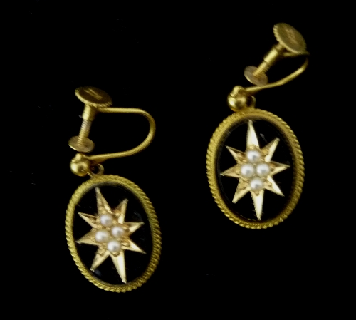 A pair of onyx and pearl ear pendants, the oval onyx centred by a pearl set starburst, in a 9ct gold