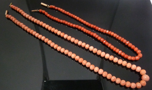 Two coral bead necklaces, one of graduated pink circular beads, the other of graduated red faceted
