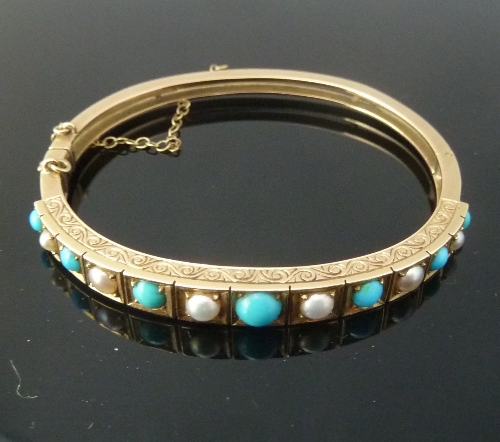 A turquoise and pearl bangle, of hinged form, one half set with alternating turquoise beads and