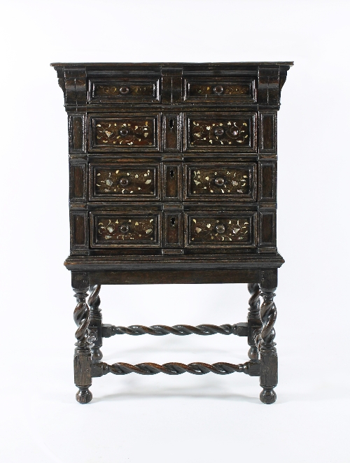 A fine and rare 17th Century oak chest on stand, the chest with four drawers with applied