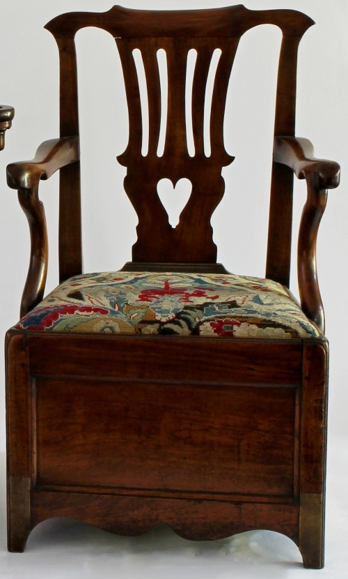 A George III walnut box seated armchair with pierced vase shaped splat, needlework drop-in seat