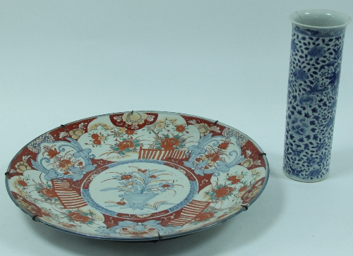 A Japanese Imari charger, decorated a vase of flowers to the centre and with floral reserves to