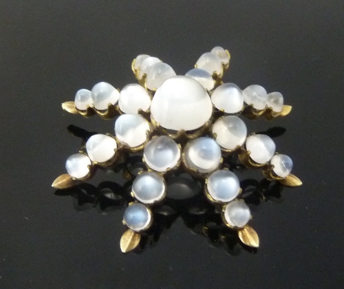 A moonstone starburst brooch, 4.5cm (1.75") diameter