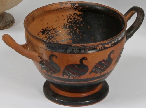An attic black figure skyphos, 6th Century BC, painted with a row of geese in black and red on a