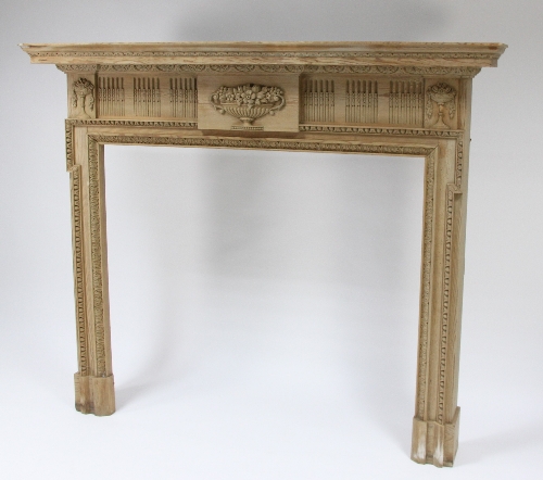 An Adam style carved pine fire surround, the frieze carved with baskets of flowers, 140cm (55") high