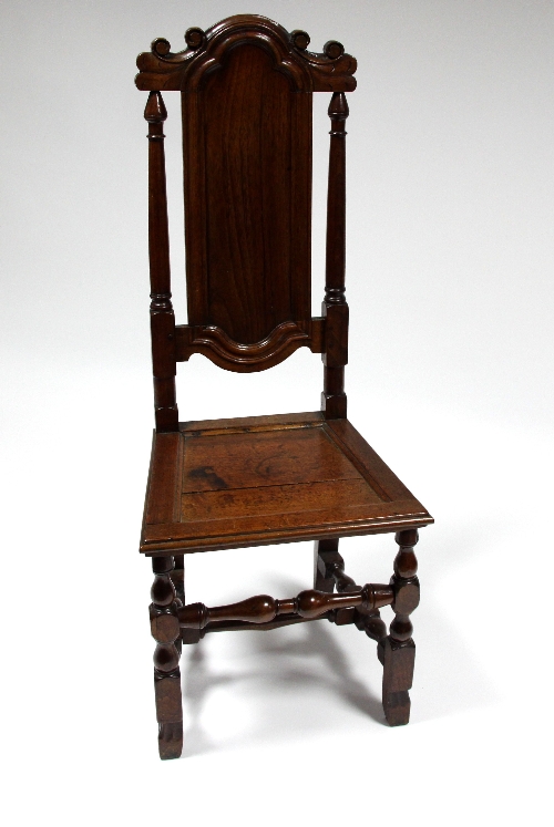 A late 17th Century oak high back chair, circa 1690, with scroll carved top, shaped back and