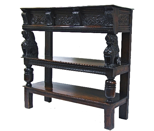 A fine and rare James I oak buffet, circa 1620, with carved frieze with central cupboard upon carved