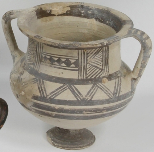 A Cypriot pottery twin handled vessel, circa 800 BC, with flared neck to globular body raised on a