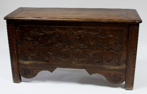 A Continental oak chest with hinged cover, the front carved fish, acanthus scrolls etc, 113cm (44.