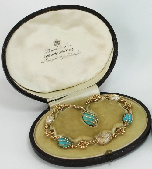 A baroque pearl and turquoise bracelet, the cage set pearl and turquoise links alternating with