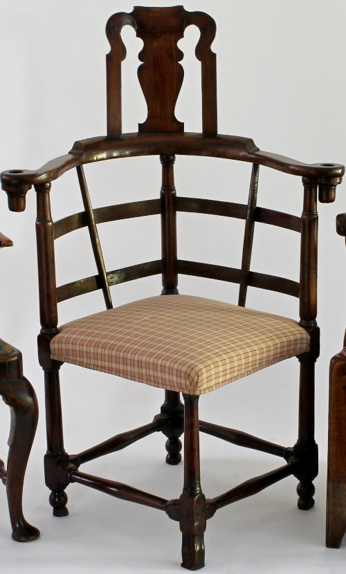 A George II walnut corner writing chair with vase shaped splat to upper back and hooped arms, on