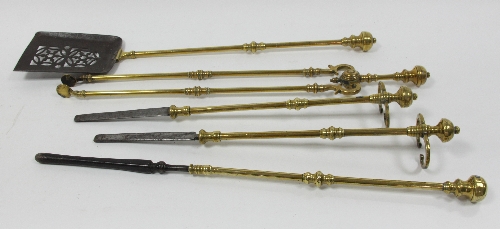 A set of brass and steel fire irons comprising pair of rests, poker, shovel and tongs