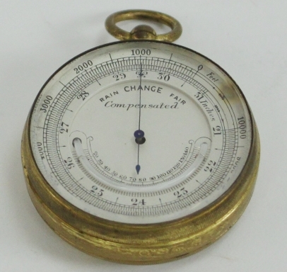 A pocket compensated barometer with crescent shaped mercury thermometer in a brass case, 5cm (2")