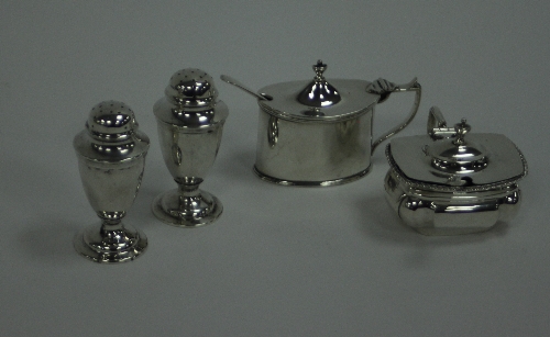 A pair of silver pepper pots, Chester 1898, of vase shape with pierced domed covers, a silver