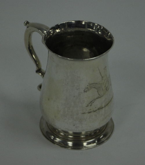 A George III silver mug, James Stamp, London 1762, of baluster form with scroll handle, engraved a