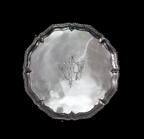 A George III silver salver, Hannam & Crouch, London 1765, with pie crust border and gadrooned rim on