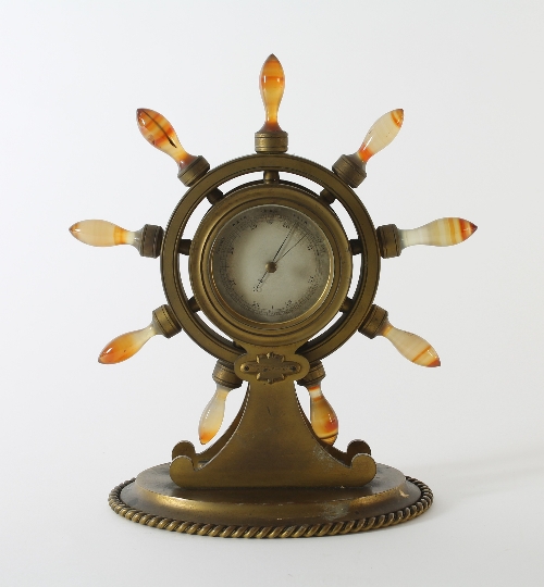 A ship's wheel aneroid barometer in an ormolu case with agate handles, Howell James & Co retail