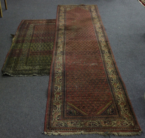 A long runner with pine cone boteh on a red ground within a white guard stripe and a similar carpet