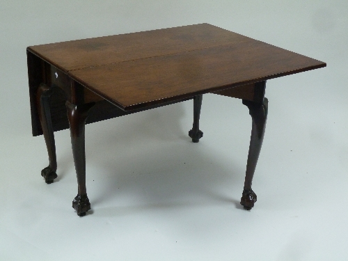 A George II rectangular two-flap table, raised on cabriole legs, with ball and claw feet 132cm (52")