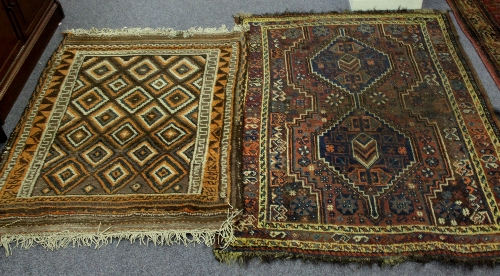 Two rugs, one with indigo medallions, the other with diamond medallions of orange and brown