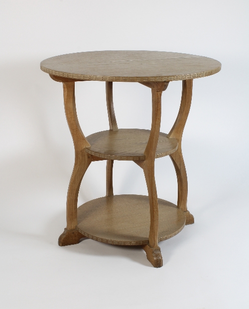 An oak occasional table by Peter Waals with circular top to four shaped legs joined by two tray