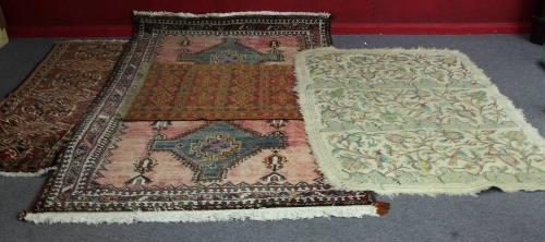 An Oriental rug with three pale blue medallion, 245cm (97") long, another with seven medallions on a