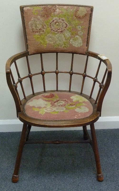 An Edwardian armchair with tapestry inset back rest and seat, the curved open frame with turned