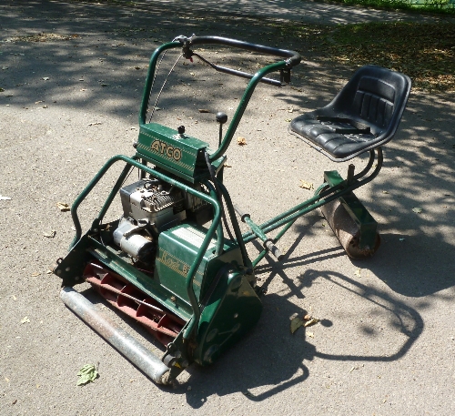 An Atco Royal B24E 24" cut lawn mower, key start with grass box and tow behind seat Condition