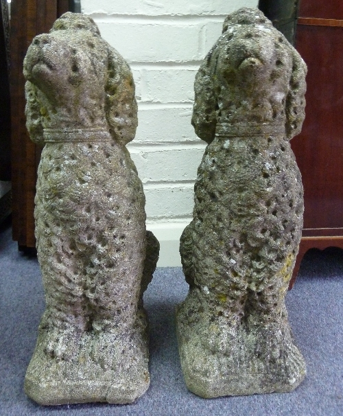 A pair of reconstituted stone poodles, 48cm (19") high Condition Report: Generally weathered, base