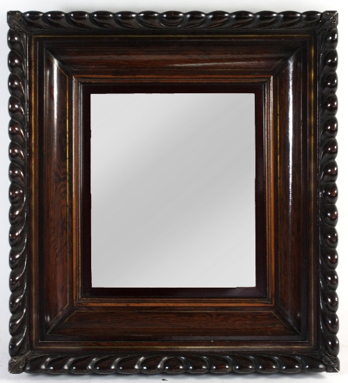 A Regency rosewood framed mirror, the rectangular glass to a concave frame with brass inlays and a