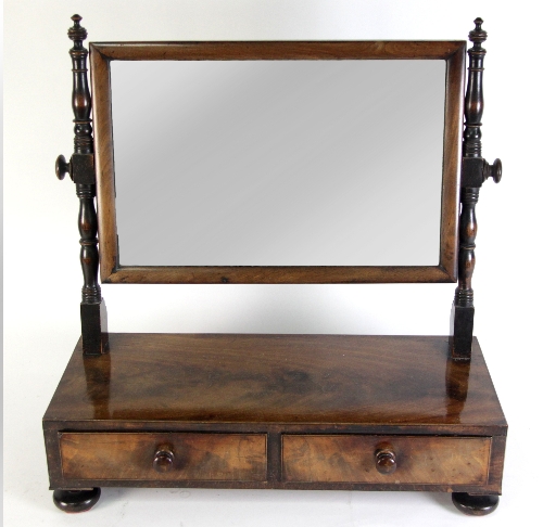 A Victorian mahogany swing frame mirror, the rectangular glass on turned supports to a box base,