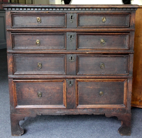 An oak chest of four long drawers with dentil moulding and moulded drawer fronts, 95cm (37.5")