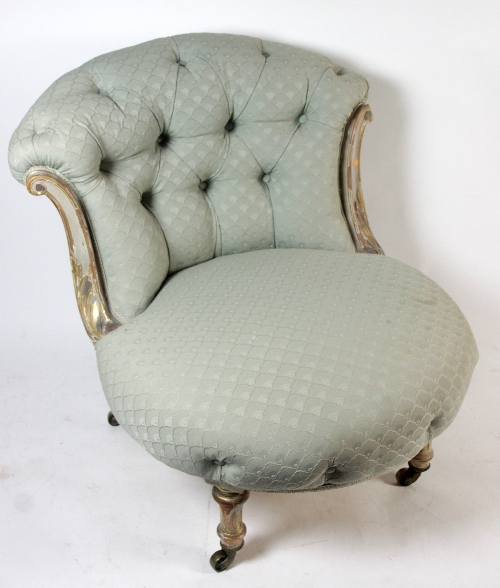 A Victorian painted and parcel gilt button upholstered tub chair, circa 1880, with leaf carved