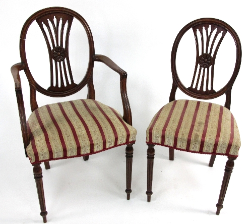 A set of five mahogany dining chairs including an arm chair, with oval backs and pierced splats